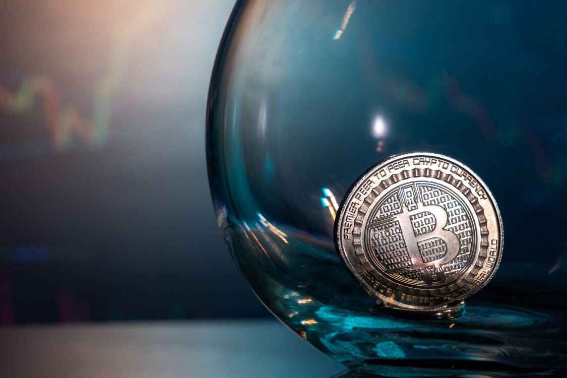 close up of a silver bitcoin on a blue reflective 2025 02 17 15 48 59 utc 1