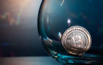 close-up-of-a-silver-bitcoin-on-a-blue-reflective-2025-02-17-15-48-59-utc-1-346x220.jpg